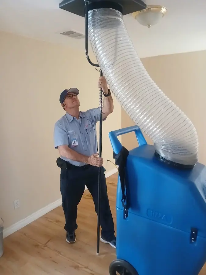 Furnace Tune-Up technician using HEPA equipment in Jenks
